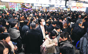 Passengers at the Sendai station after train services were suspended following an earthquake in Japan on Friday.