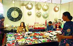 Women take a look at decorative items at Punjab International Trade Expo in Amritsar on Saturday