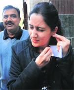A candidate removes her gold earrings before taking the MD/MS exam. 