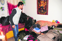 A Sector 41 resident shows a large number of bags that the candidates left at his home in the absence of proper arrangements at Shivalik Public School during the PGI MD/MS examination in Chandigarh on Saturday.