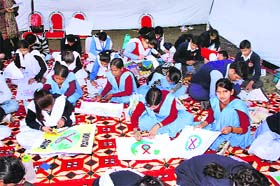 School students participate in a poster-making and slogan writing competition in Kurukshetra on Saturday