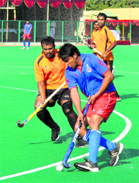 Player intercepts a ball during the All India Police hockey championship in Jammu on Saturday.