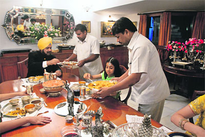 Randhir Singh with his youngest grand-daughter Sia. being served khatta meetha pulao by Mumtaz. The latter has been with the royal family for many years