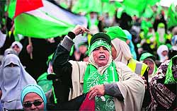 Supporters take part in a rally marking the 25th anniversary of the founding of Hamas in Gaza City on Saturday