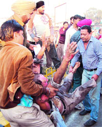 A police team rescues Surinder Kumar, who tried to commit suicide with self-immolation near Hall Gate chowk in Amritsar on Sunday. 