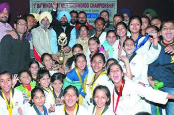 Members of the St. Josephs Convent Schools taekwondo team in an elated mood after winning the overall trophy in the district-level championship