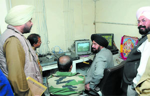 The SP (H) Gurmeet Singh watches the CCTV footage.
