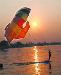 A man enjoys para-gliding at the Thermal lake on Sunday which was the last day of the adventure sports carnival in the city.