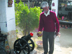 Rampal (right) with his clay cannon.