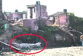 The sand bags placed by villagers to prevent damage from overflowing rivulet