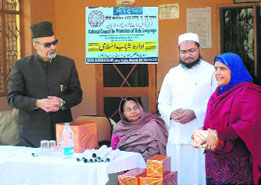 S Farooq, a social worker, distributes certificates to a successful candidate of the Urdu examination conducted by the National Council for Promotion of Urdu Language in Dehradun.