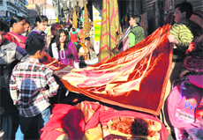 Residents purchase woollen clothes at the Hari Market in Jammu on Sunday. 