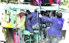 Flouting traffic rules auto-rickshaw drivers overload their vehicles while ferrying school children to and from schools in Jalandhar.