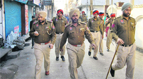 The police inspects the site where two groups clashed in Nizatam Nagar in Jalandhar on Sunday.