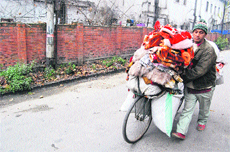 A man carries woollens on his bicycle as Kashmir witnessed yet another chilly day on Sunday.