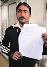 Jagdish Chand shows documents in which he has narrated his ordeal, and (inset) his son Shivam. 