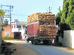 An overloaded truck passes from under the power cables at Mandiani village.