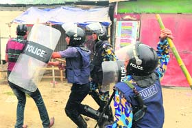 The police counters a Bangladesh Nationalist Party supporter during a protest in Narayanganj, on the outskirts of Dhaka, on Sunday