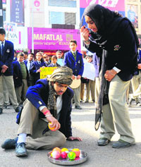 Students of Saupins School, Chandigarh and Mohali, present a street play to mark International Anti-Corruption Day at Sector 19 in Chandigarh on Monday. 