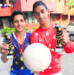 Prabhsukhan and Sumit, who bagged the title of best players at the 58th National School Games, with their trophies at Sector 42 in Chandigarh.