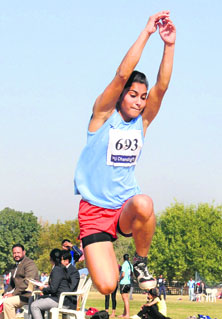 A player takes part in the triple jump event during the Panjab University Athletics Meet at the PU in Chandigarh on Monday.