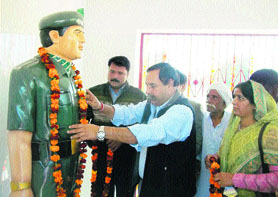Congress legislator Rao Yaduvender Singh unveils Rezang La War martyr Dharam Pal Yadavs statue at Juddi village in Rewari district.