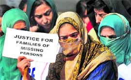 Kashmiri women sit on a dharna near Parliament to mark World Human Rights Day in New Delhi on Monday.