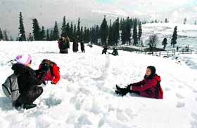 Tourists enjoying the snow at Ski resort in Gulmarg on Monday.