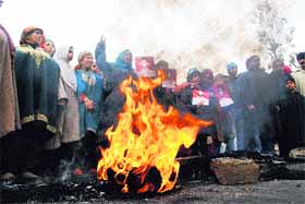 Relatives of Showkat Ahmad Khan hold a protest in Srinagar on Monday.