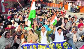 BJP workers along with members of the PoJK Refugee United Front protest for their right on Human Rights Day in Jammu on Monday.