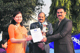 Air Force Wives Welfare Association president Mamta Patange presents a citation to Jammu Air Force School principal on Monday. 