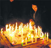 Tibetans living in exile light candles as they take part in a candlelight march in New Delhi on Monday to mark World Human Rights Day