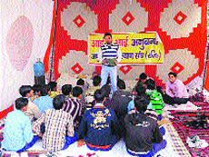The sacked president of the ITI Contractual Instructors Association teaches his students at the dharna site in Jind on Tuesday.