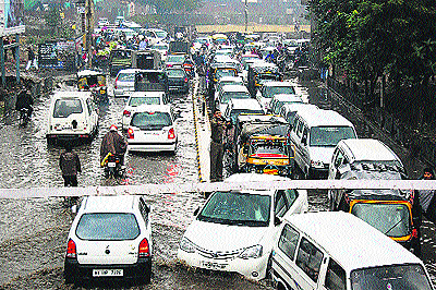 Vehicles move at a snails pace at the waterlogged railway underbridge near Shani Mandir at Sonepat on Tuesday.