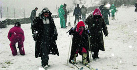 Tourists ski near Nehru Kund, about 5 km from Manali, on Tuesday. 