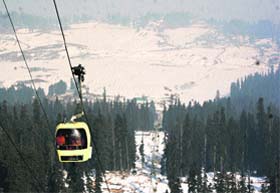 TOUCHING HEIGHTS: Tourists take a ride in a cable car at Gulmarg