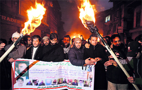 Activists of the Jammu and Kashmir Liberation front during a torch light protest in Srinagar on Monday.