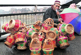 A vendor sells kangris on the Amira Kadal bridge in Srinagar on Tuesday.