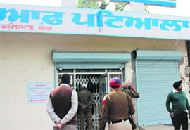 Policemen at the State Bank of Patiala in Kalyan village of Patiala district following a theft of over Rs 5.5 lakh on Tuesday. 