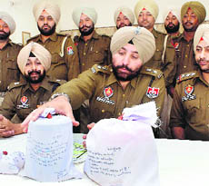 Police officers display the contraband seized, at Shambhu police station on Monday. 