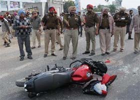 SSP Ravcharan Singh Brar (centre) points at the Pulsar bike which the boys were riding when they met with an accident near lake number three of the Guru Nanak Dev Thermal Plant in Bathinda on Wednesday