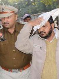 Mewa Singh, accused of murdering his wife, being taken away by the police
