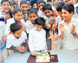 Budding cricketers cut a cake to celebrate the birthday of Yuvraj Singh at Government Model Senior Secondary School, Sector 19, in Chandigarh on Wednesday. 