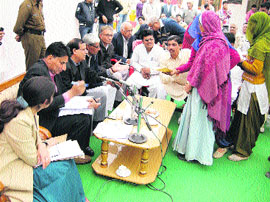 Deputy Commissioner ML Kaushik (third from left) hears public grievances during his visit for a night sojourn at Bhattu Kalan in Fatehabad. 