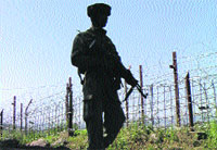 A soldier patrols along the Line of Control