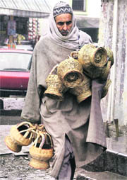 A man carries kangris to beat the chill in Srinagar. 