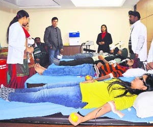 Volunteers donate blood during a camp at Bharat Nagar Chowk in Ludhiana on Wednesday. 