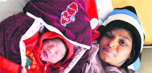 Gurvinder Kaur with her newborn at the DMCH in Ludhiana.
