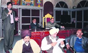 The regional project coordinator of the Rajiv Awaas Yojna, Dr Khatibullah Sheikh (left), addresses municipal councillors in Amritsar on Thursday