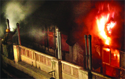 A firefighter tries to douse the flames in a building at Bhagirath Place, Chandni Chowk, in Delhi on Thursday. Tribune photo: Manas Ranjan Bhui
